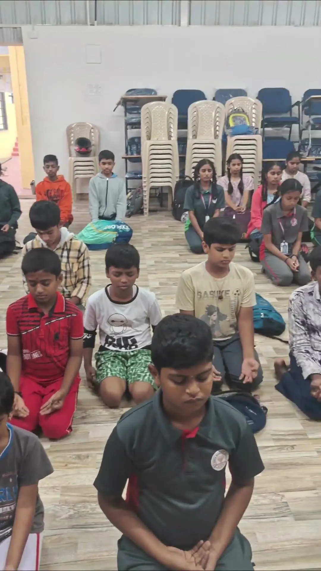Students practising Vajrasana together